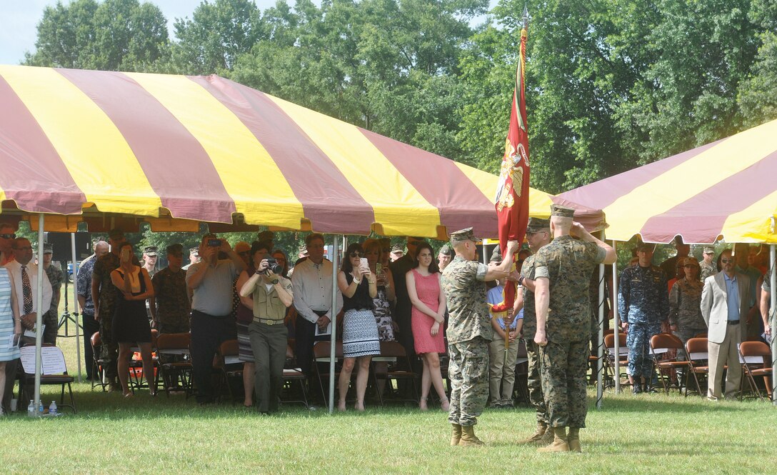 Col. Todd Oneto, H&S Bn. commander passes on the colors to Col. John Atkinson as part of change of command ceremonies held at Lejuene Hall today.