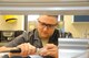 Senior Airman Joseph Dumancas, 88th Dental Squadron Dental Lab technician, polishes a specially-designed dental appliance designed to hold an accelerometer used in the 711th Human Performance Wing’s research on the effects of an ejection seat event on the human body. The collected data helps them determine how ejection seats and related equipment could be made safer for aviators to use, when needed. (U.S. Air Force photo/Will Huntington)