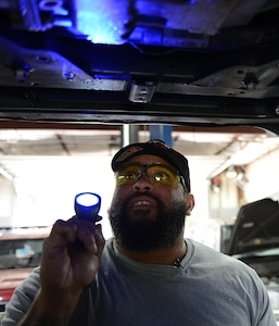 Corey Williams, Fort Eustis Auto Craft Center and Inspection Station mechanic, conducts an inspection on a vehicle at Joint Base Langley-Eustis, Va., June 28, 2017. Williams carried over his work ethic, motivation and mechanic skills from his time as a Soldier into his new line of work as a civilian on the installation. (U.S. Air Force photo/Staff Sgt. Teresa J. Cleveland)