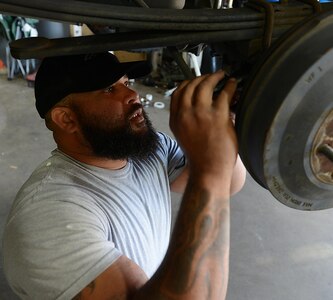 Corey Williams, Fort Eustis Auto Craft Center and Inspection Station mechanic, checks the breaks on a vehicle at Joint Base Langley-Eustis, Va., June 28, 2017. According to Williams, he learned the importance of integrity and discipline during his time in the U.S. Army and applies the things he learned in his current civilian career path. (U.S. Air Force photo/Staff Sgt. Teresa J. Cleveland)