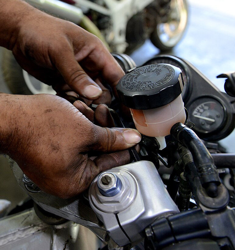 Corey Williams, Fort Eustis Auto Craft Center and Inspection Station mechanic, conducts maintenance on a motorcycle at Joint Base Langley-Eustis, Va., June 28, 2017. Williams, a former U.S. Army Soldier, was a light vehicle mechanic assigned to the 149th Transportation Company, 10th Transportation Battalion, 7th Transportation Brigade (Expeditionary). (U.S. Air Force photo/Staff Sgt. Teresa J. Cleveland)