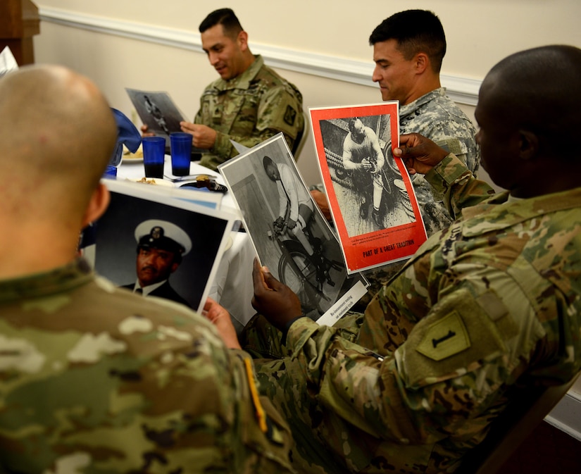 U.S. Army Soldiers view photos of Carl Brashear, the first African American U.S. Navy diver, during the Fort Eustis Diamond Council’s leadership luncheon at Joint Base Langley-Eustis, Va., June 28, 2017. The Diamond Council hosts the leadership luncheon quarterly to allow NCOs of all services to learn and network across the branches of service and units in the local area  (U.S. Air Force photo/Staff Sgt. Teresa J. Cleveland)