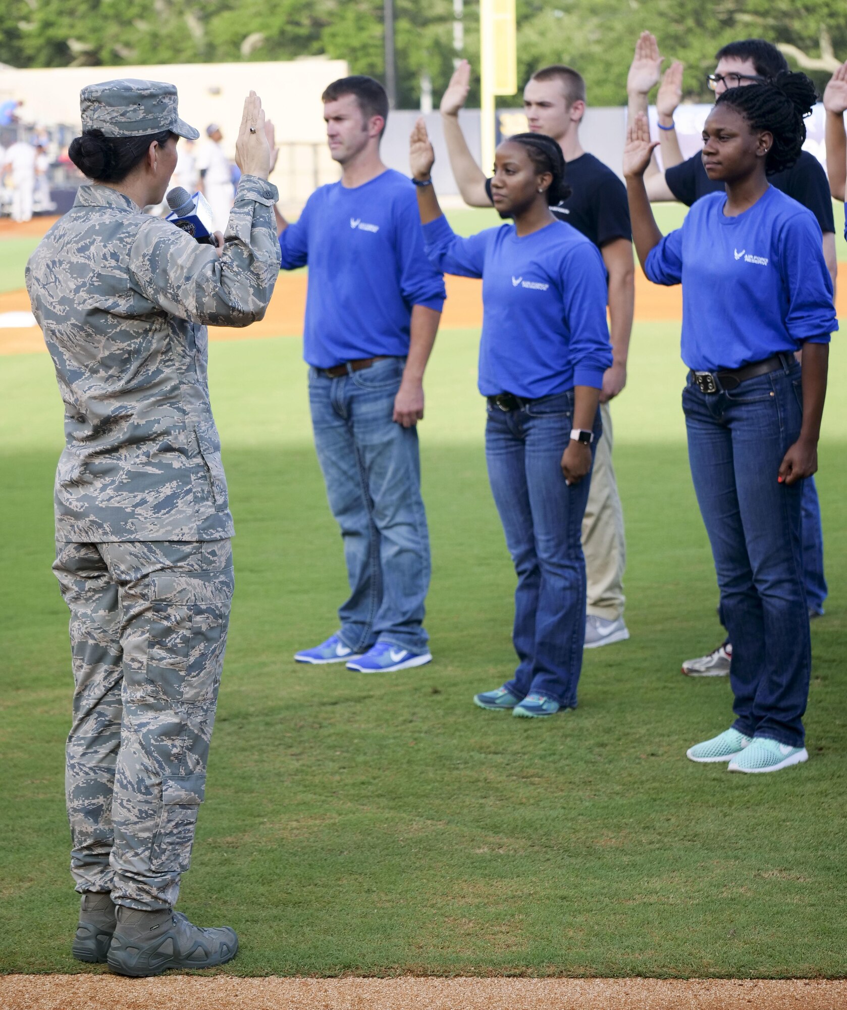 Col. Debra Lovette, 81st Training Wing commander, recites the oath of office to Air Force delayed enlistment program recruits during the Biloxi Shuckers Minor League Baseball team’s military appreciation night July 8, 2017, in Biloxi, Miss. The Shuckers recognized and honored service members and their families for the dedication, commitment and sacrifices they make for the nation. (U.S. Air Force photo by Capt. David J. Murphy)