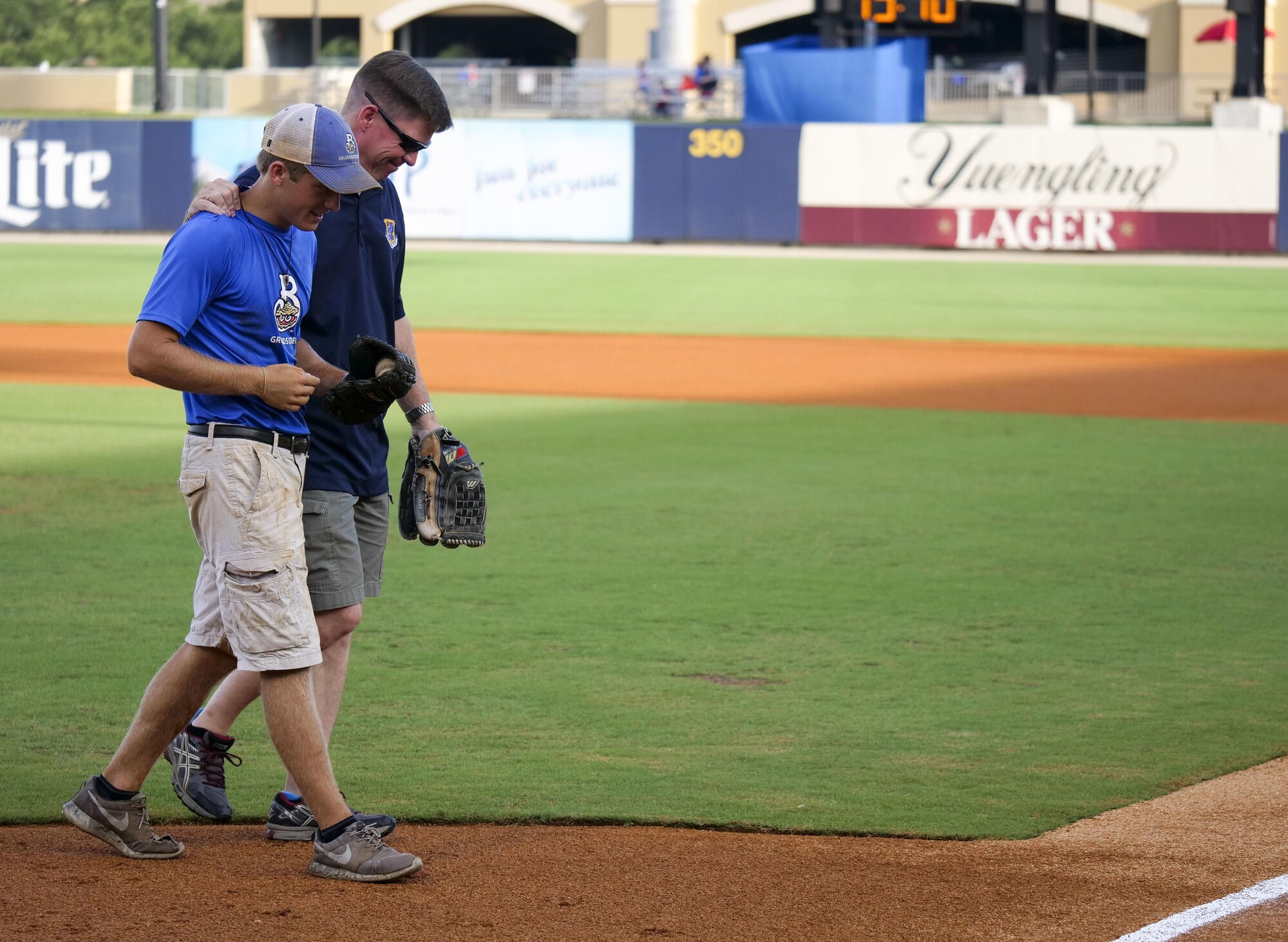 Col. C. Mike Smith, 81st Training Wing vice commander, walks off the field with his son, Mac, after throwing the first pitch during the Biloxi Shuckers Minor League Baseball team’s military appreciation night July 8, 2017, in Biloxi, Miss. The Shuckers recognized and honored service members and their families for the dedication, commitment and sacrifices they make for the nation. 

(U.S. Air Force photo by Capt. David J. Murphy)