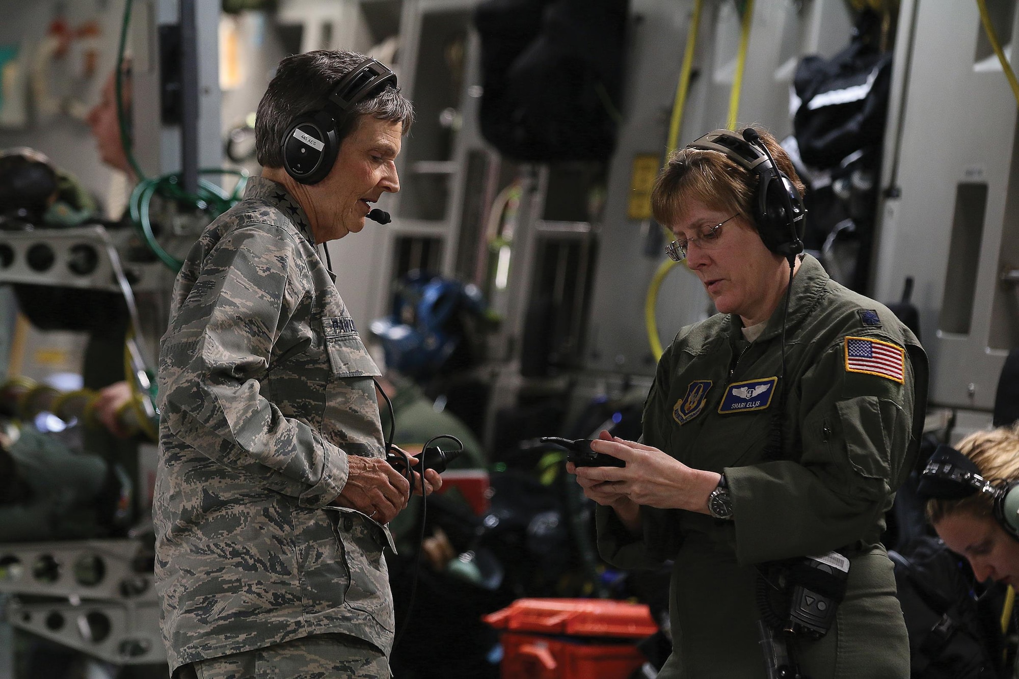 Lt. Col. Shari Ellis, 445th Aeromedical Evacuation Squadron flight nurse, shows Gen. Ellen Pawlikowski, Commander, Air Force Materiel Command, equipment AES Airmen use to communicate with each other during various missions they fly on. The general flew onboard a 445th Airlift Wing C-17 Globemaster III used for an aeromedical evacuation training flight June 20, 2017. (U.S. Air Force photo/Tech. Sgt. Patrick O’Reilly)