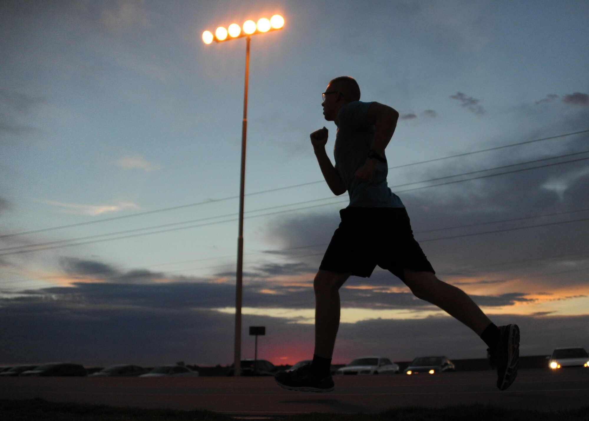 An Airmen assigned to the 56th Fighter Wing participates in a 1.5 mile run at Luke Air Force Base, Ariz., July 10, 2017. The run clinic is held at the base track every Monday, Wednesday and Friday at 5 a.m. and includes different segments of running, sit-ups and pushups. (U.S. Air Force photo/Airman 1st Class Caleb Worpel)