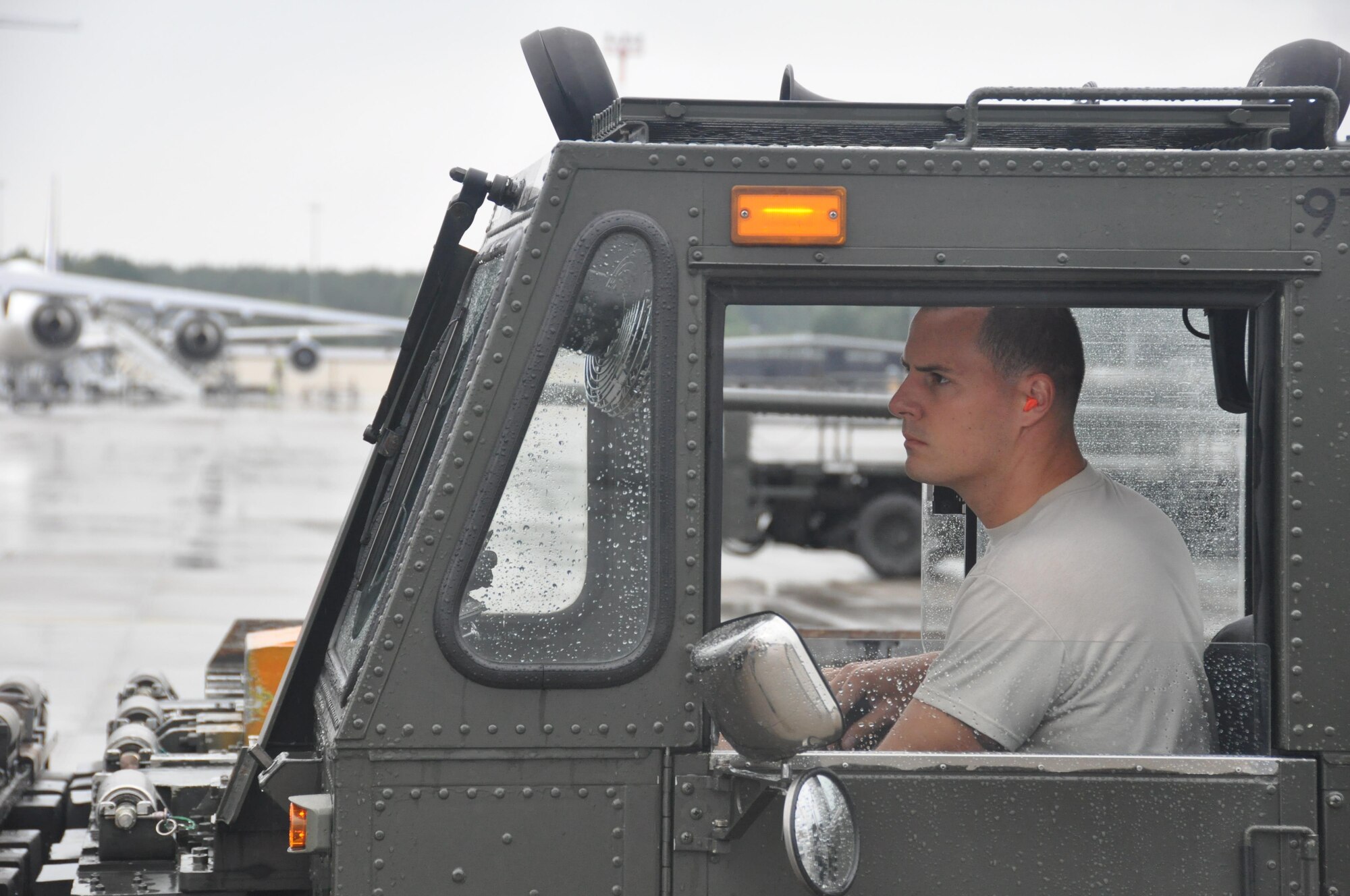 Staff Sgt. Tyler Cross, Air Transportation Journeyman with the 81st Aerial Port Squadron out of Joint Base Charleston, S.C., operates a 60K cargo handler on the ramp at Ramstein AB, Germany, July 12, 2017.  Citizen Airmen of the 128th LRS and 81st APS performed two weeks of annual training at Ramstein in order to maintain readiness and familiarization with high-volume aerial port operations.  (U.S. Air Force photo by 1st Lt. Justin Clark)