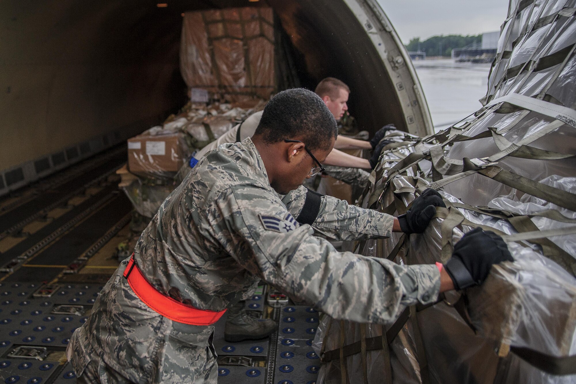 Senior Airman Ronnie Baker, Air Transportation Journeyman with the 81st Aerial Port Squadron out of Joint Base Charleston, S.C., offloads palletized air cargo on the ramp at Ramstein AB, Germany, July 12, 2017.  Citizen Airmen of the 81st APS performed two weeks of annual training at Ramstein in order to maintain readiness and familiarization with high-volume aerial port operations.  (U.S. Air Force photo by Senior Airman Jonathan Lane)
