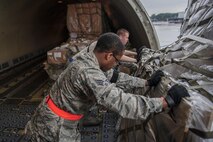 Senior Airman Ronnie Baker, Air Transportation Journeyman with the 81st Aerial Port Squadron out of Joint Base Charleston, S.C., offloads palletized air cargo on the ramp at Ramstein AB, Germany, July 12, 2017.  Citizen Airmen of the 81st APS performed two weeks of annual training at Ramstein in order to maintain readiness and familiarization with high-volume aerial port operations.  (U.S. Air Force photo by Senior Airman Jonathan Lane)