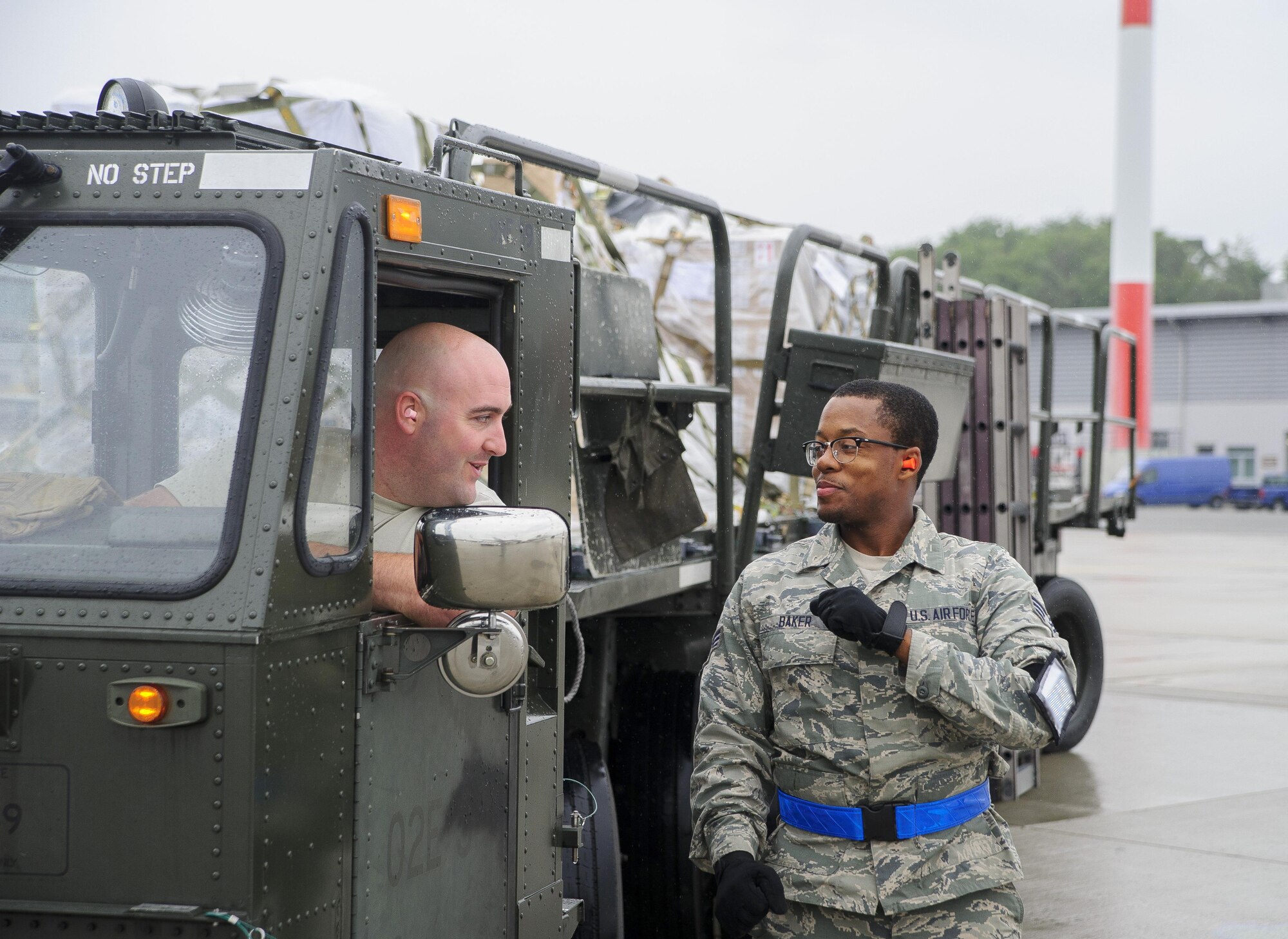 Staff Sgt. Anthony Pokorny and Senior Airman Ronnie Baker, Air Transportation Journeymen with the 81st Aerial Port Squadron out of Joint Base Charleston, S.C., prepare to offload air cargo on the ramp at Ramstein AB, Germany, July 12, 2017.  Citizen Airmen of the 81st APS performed two weeks of annual training at Ramstein in order to maintain readiness and familiarization with high-volume aerial port operations.  (U.S. Air Force photo by Senior Airman Jonathan Lane)