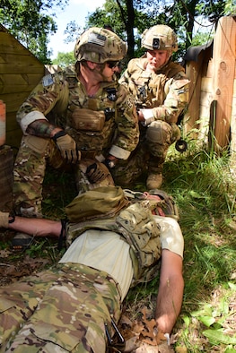 Tech. Sgt. Matthew Vandermolen, left, and Tech. Sgt. Erich J. Sanford, explosive ordnance disposal specialists with the Air National Guard's 115th Fighter Wing in Madison, Wis. provide emergency first aid to an injured team member during the Audacious Warrior exercise at Fort McCoy, Wis., July 27, 2017. The 12 day long exercise utilized the extensive training facilities of Volk Field Combat Readiness Training Center and Fort McCoy Total Force Training Center to provide EOD teams from eight different states comprehensive classroom and scenario based training in EOD tactics and procedures difficult to obtain at their respective home stations. (U.S. Air National Guard Photo by Master Sgt. Paul Gorman)