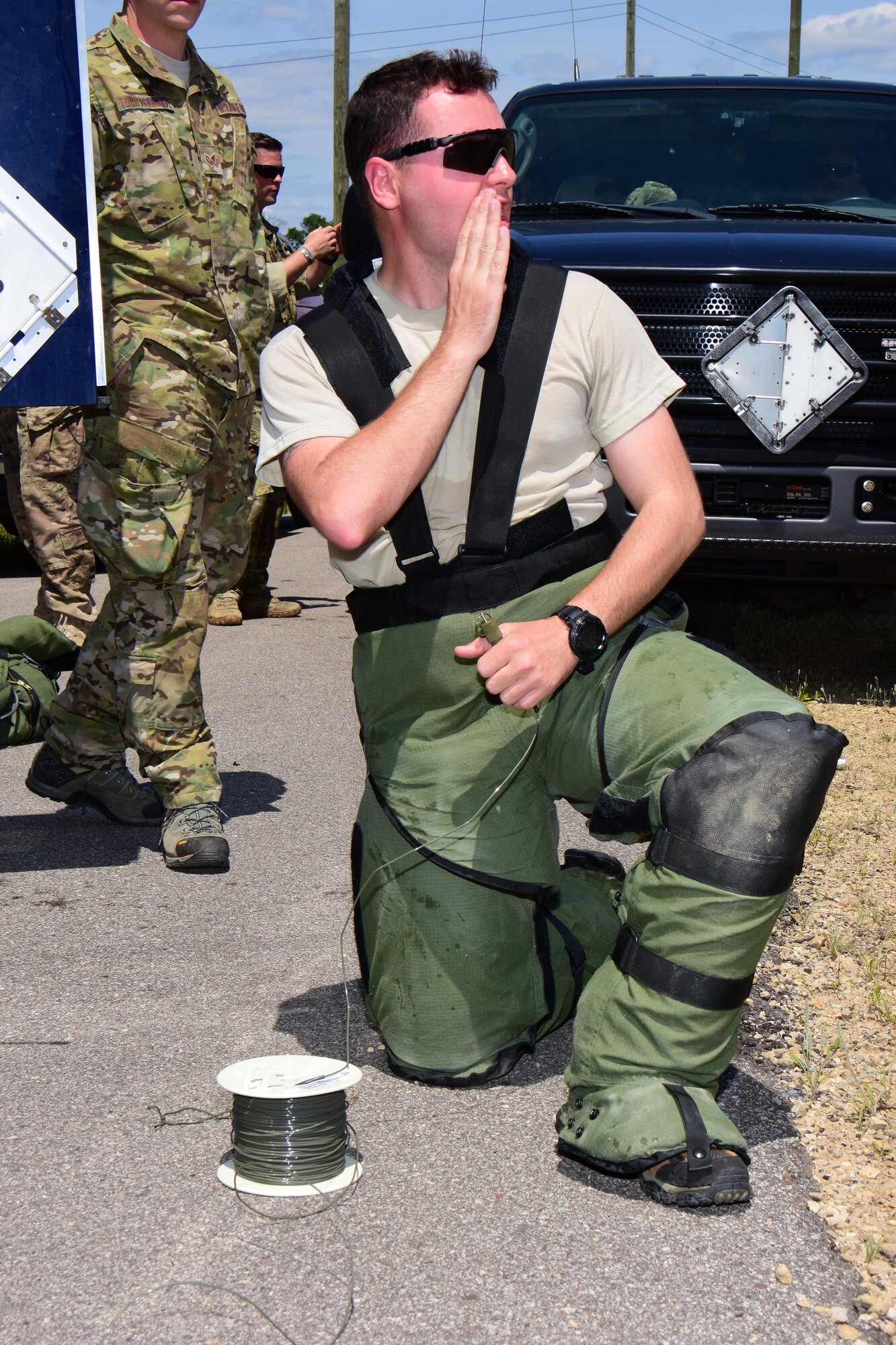 Senior Airman Bentley Davis, explosive ordnance disposal specialist with the Air National Guard's 147th Reconnaissance Wing in Houston, Texas warns area personnel of the impending explosion prior to detonating an improvised explosive device disruption charge during the Audacious Warrior exercise at Fort McCoy, Wis., July 27, 2017. The 12 day long exercise utilized the extensive training facilities of Volk Field Combat Readiness Training Center and Fort McCoy Total Force Training Center to provide EOD teams from eight different states comprehensive classroom and scenario based training in EOD tactics and procedures difficult to obtain at their respective home stations. (U.S. Air National Guard Photo by Master Sgt. Paul Gorman)