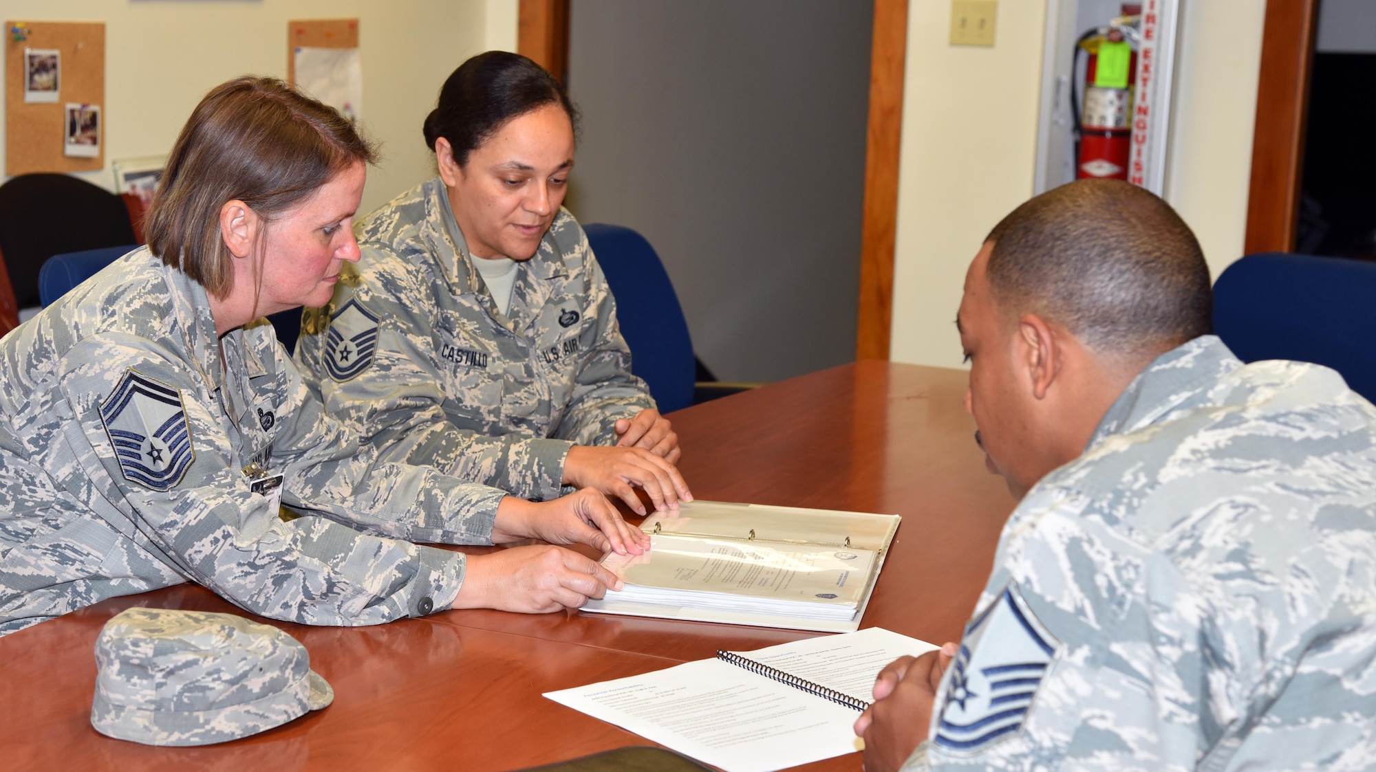 Senior Master Sgt. Marguerite Gallegos, left, and Master Sgt. Kenneth Plummer, right, Air Force Reserve Command personnel inspection team members, interview Master Sgt. Marian Castillo, 920th Force Support Squadron installation personnel readiness specialist, during the 920th Rescue Wing Unit Effectiveness Inspection Capstone July 9, 2017 at Patrick Air Force Base, Florida. (U.S. Air Force photo/Tech. Sgt. Lindsey Maurice)