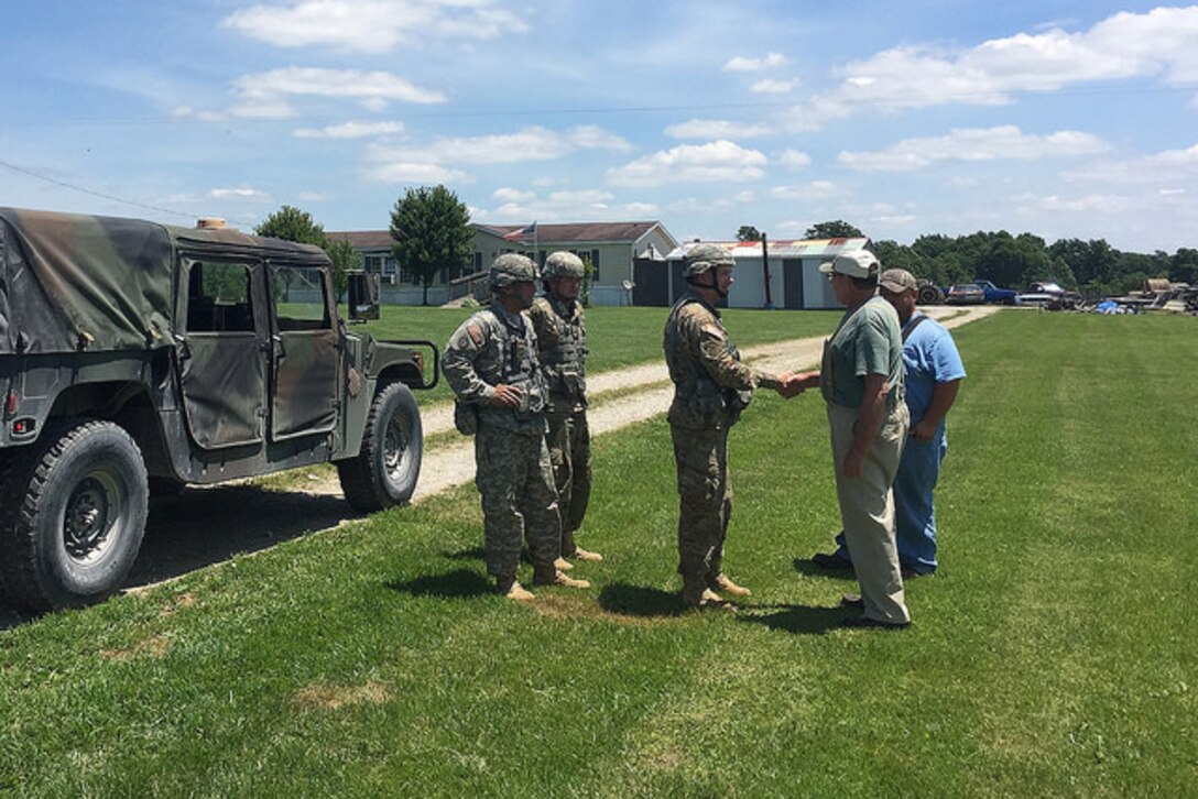 Army Lt. Col. Andrew Bates, commander of the Kentucky Army National Guard’s 2nd Battalion, 138th Field Artillery Brigade, thanks Robert Allen Jones Sr. for his family's cooperation in the battalion's signal operations, June 10, 2017. Army photo