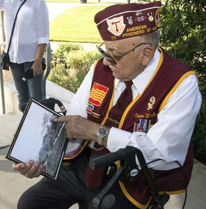 Oscar Cortez, a former Korean War POW, served in the same unit with Army Cpl. Frank Sandoval. He and Sandoval were captured at the same time and were both held in Camp 3, a POW camp near Changsong, North Korea. Cortez presented a framed photo of the unit he and Sandoval served in while they were in action to Sandoval’s sons July 11. Cortez, 85, said the photo was taken three to four days before their unit was captured.