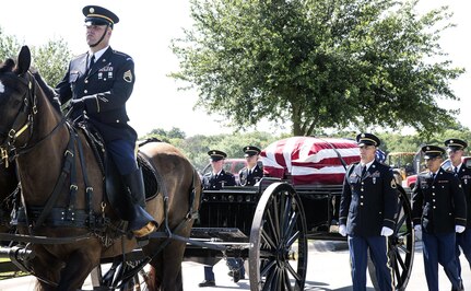 Members of the Joint Base San Antonio-Fort Sam Houston Honor Guard escort the caisson carrying the coffin with the remains of Army Cpl. Frank Sandoval to the assembly area at the Fort Sam Houston National Cemetery July 11.