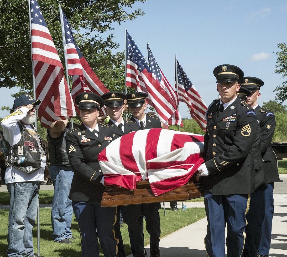 Members of the Joint Base San Antonio-Fort Sam Houston Honor Guard carry the coffin with the remains of Army Cpl. Frank Sandoval past members of the Patriot Guard Riders on the way to the assembly area at the Fort Sam Houston National Cemetery July 11.