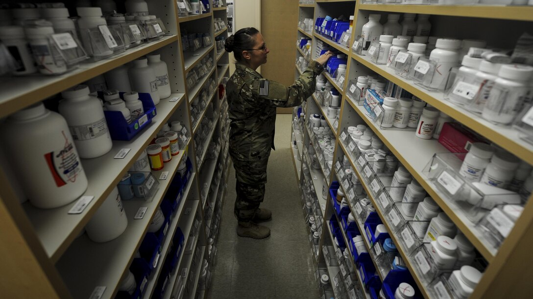 Tech. Sgt. Christina Easter, a pharmacy flight chief with the 1st Special Operations Medical Group, retrieves medication for prescription refill at Hurlburt Field, Fla., July 11, 2017. The 1st SOMDG supplies patients with a wide variety of medications including Motrin, Synthroid and Alegra-D. (U.S. Air Force photo by Airman 1st Class Dennis Spain)