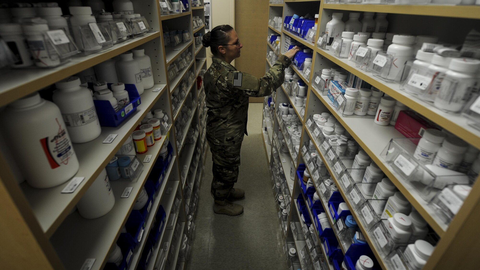 Tech. Sgt. Christina Easter, a pharmacy flight chief with the 1st Special Operations Medical Group, retrieves medication for prescription refill at Hurlburt Field, Fla., July 11, 2017. The 1st SOMDG supplies patients with a wide variety of medications including Motrin, Synthroid and Alegra-D. (U.S. Air Force photo by Airman 1st Class Dennis Spain)