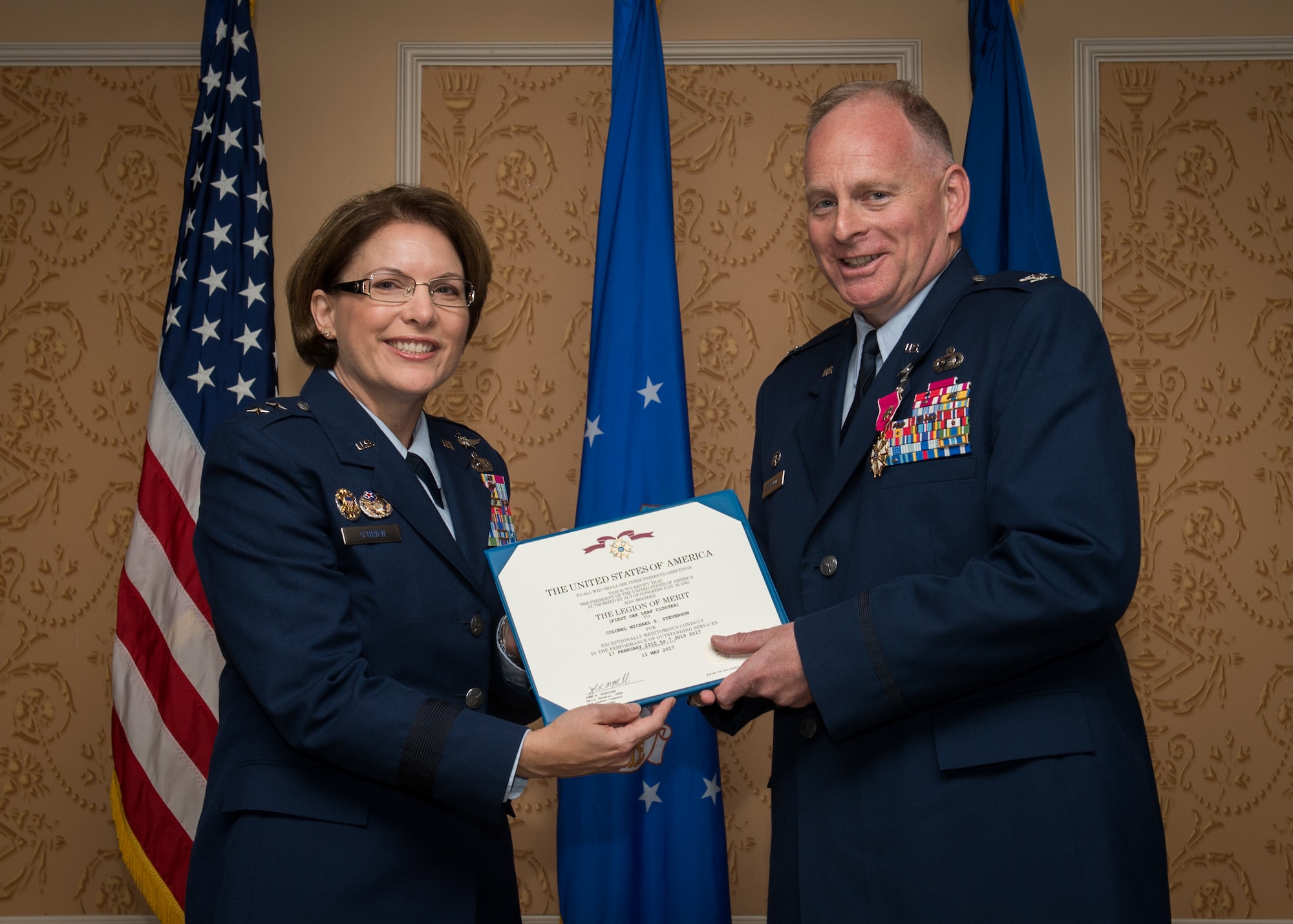 Maj. Gen. Mary F. O’Brien, commander, 25th Air Force, presents the Legion of Merit to Col. Michael Stevenson, outgoing commander, during the 363rd Intelligence, Surveillance and Reconnaissance Wing change of command ceremony July 7, 2017.  (U.S. Air Force Photo by Staff Sgt. Areca Bell)