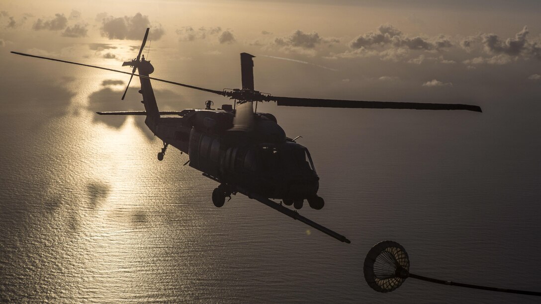 An Air Force HH-60G Pave Hawk helicopter receives fuel from an HC-130P/N King aircraft while traveling to assist in a rescue mission approximately 500 nautical miles off the east coast of southern Florida, July 7, 2017. About 80 airmen and four aircraft assigned to the 920th Rescue Wing assisted in the mission to rescue two German citizens whose vessel caught fire. Air Force photo by Master Sgt. Mark Borosch