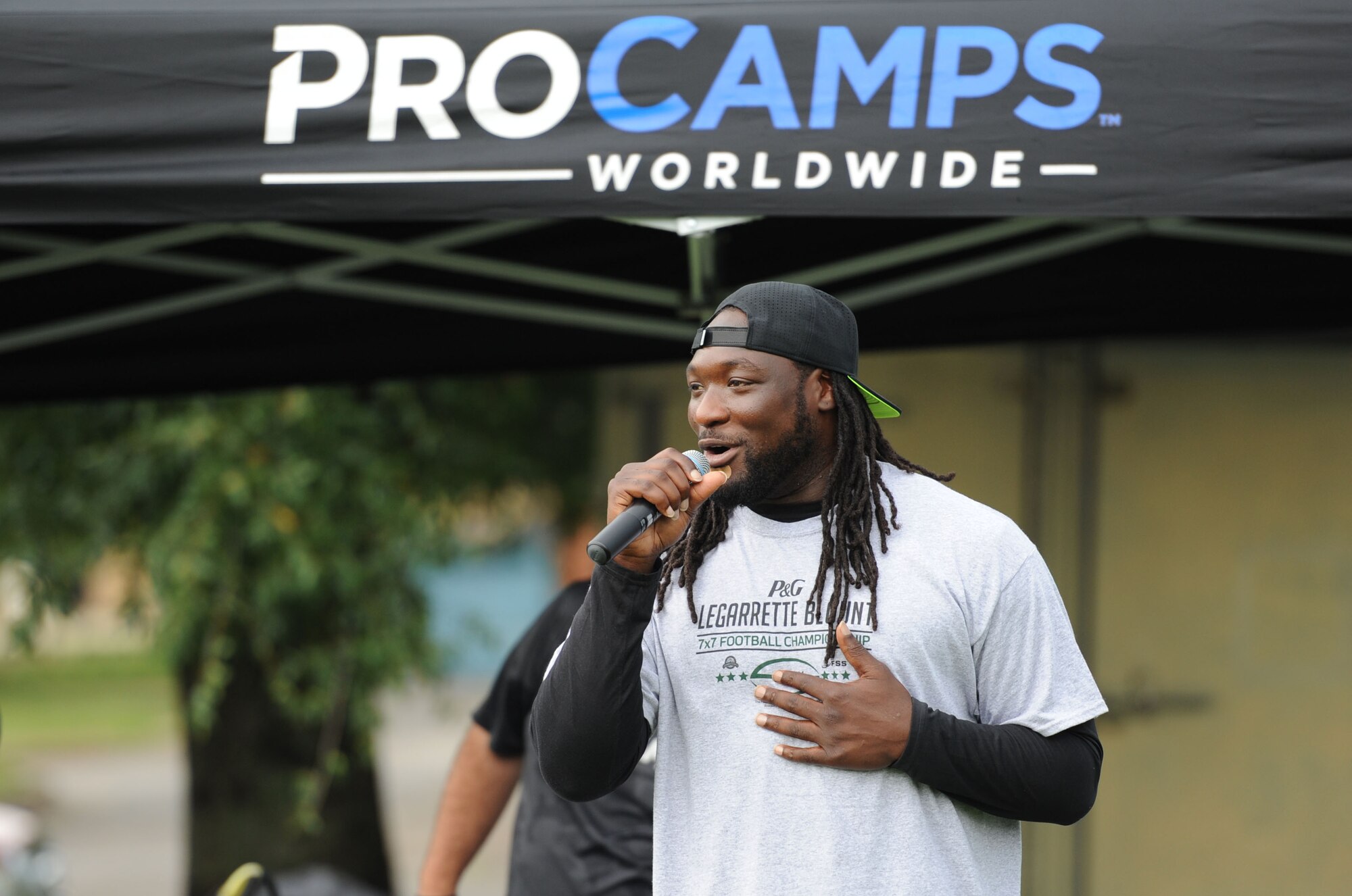 LeGarrette Blount, Philadelphia Eagles National Football League running back, delivers welcoming remarks during the P&G LeGarrette Blount 7x7 Football Championship July 8, 2017, on Keesler Air Force Base, Miss. Blount hosted the two-day camp consisting of 10 flag football teams from Keesler and the local community to promote the importance of living an active and healthy lifestyle. (U.S. Air Force photo by Kemberly Groue) 