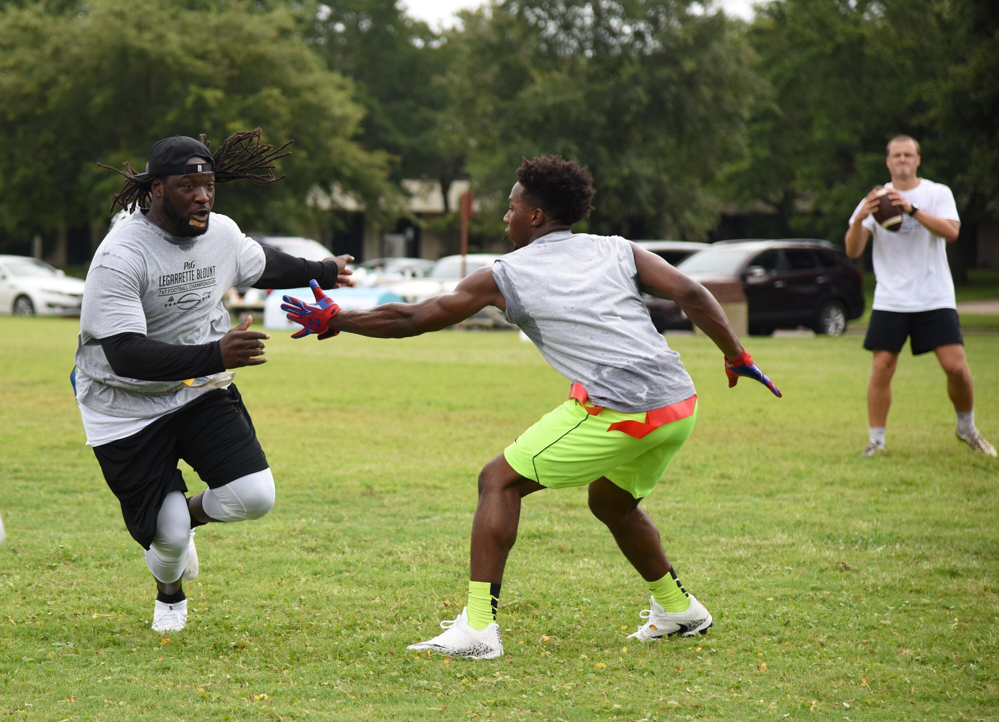 Kries Moffett, 335th Training Squadron team member, blocks LeGarrette Blount, Philadelphia Eagles National Football League running back, during the P&G LeGarrette Blount 7x7 Football Championship July 8, 2017, on Keesler Air Force Base, Miss. Blount hosted the two-day camp consisting of 10 flag football teams from Keesler and the local community to promote the importance of living an active and healthy lifestyle. (U.S. Air Force photo by Kemberly Groue) 