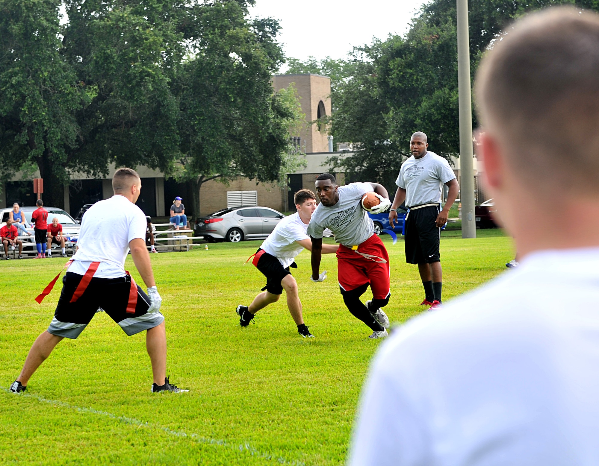 Airman 1st Class Keshaun Survine, 81st Security Forces Squadron base defense operation center controller, runs with the football during the P&G LeGarrette Blount 7x7 Football Championship July 8, 2017, on Keesler Air Force Base, Miss. Blount, Philadelphia Eagles National Football League running back, hosted the two-day camp consisting of 10 flag football teams from Keesler and the local community to promote the importance of living an active and healthy lifestyle. (U.S. Air Force photo by Airman 1st Class Suzanna Plotnikov)