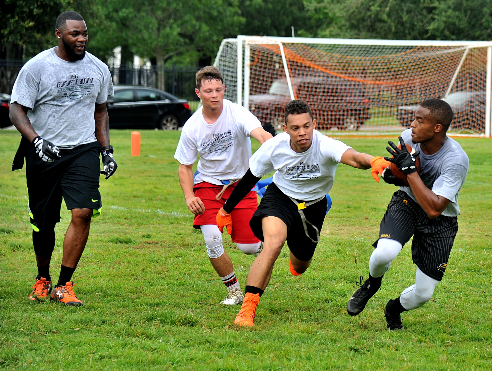 P&G LeGarrette Blount 7x7 Football Championship attendees play a flag football game July 8, 2017, on Keesler Air Force Base, Miss. Blount, Philadelphia Eagles National Football League running back, hosted the two-day camp consisting of 10 flag football teams from Keesler and the local community to promote the importance of living an active and healthy lifestyle. (U.S. Air Force photo by Airman 1st Class Suzanna Plotnikov)