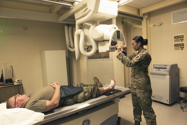 Sgt. 1st Class Trini Ta’s Call to Duty as a radiology technician at Soto Cano Air Base includes providing service for Joint Task Force-Bravo personnel as well as military working dogs, ensuring providers get the right images to help their patients. Sgt. Ta receives a patient at the Medical Element July 5th, 2017. 