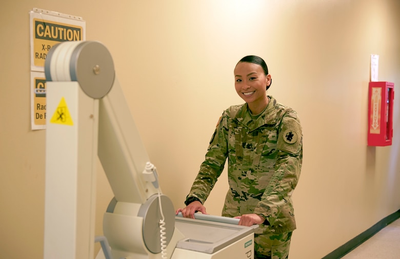 Sgt. 1st Class Trini Ta’s Call to Duty as a radiology technician at Soto Cano Air Base includes providing service for Joint Task Force-Bravo personnel as well as military working dogs, ensuring providers get the right images to help their patients. Sgt. Ta moves radiology equipment at the Medical Element July 5th, 2017. 