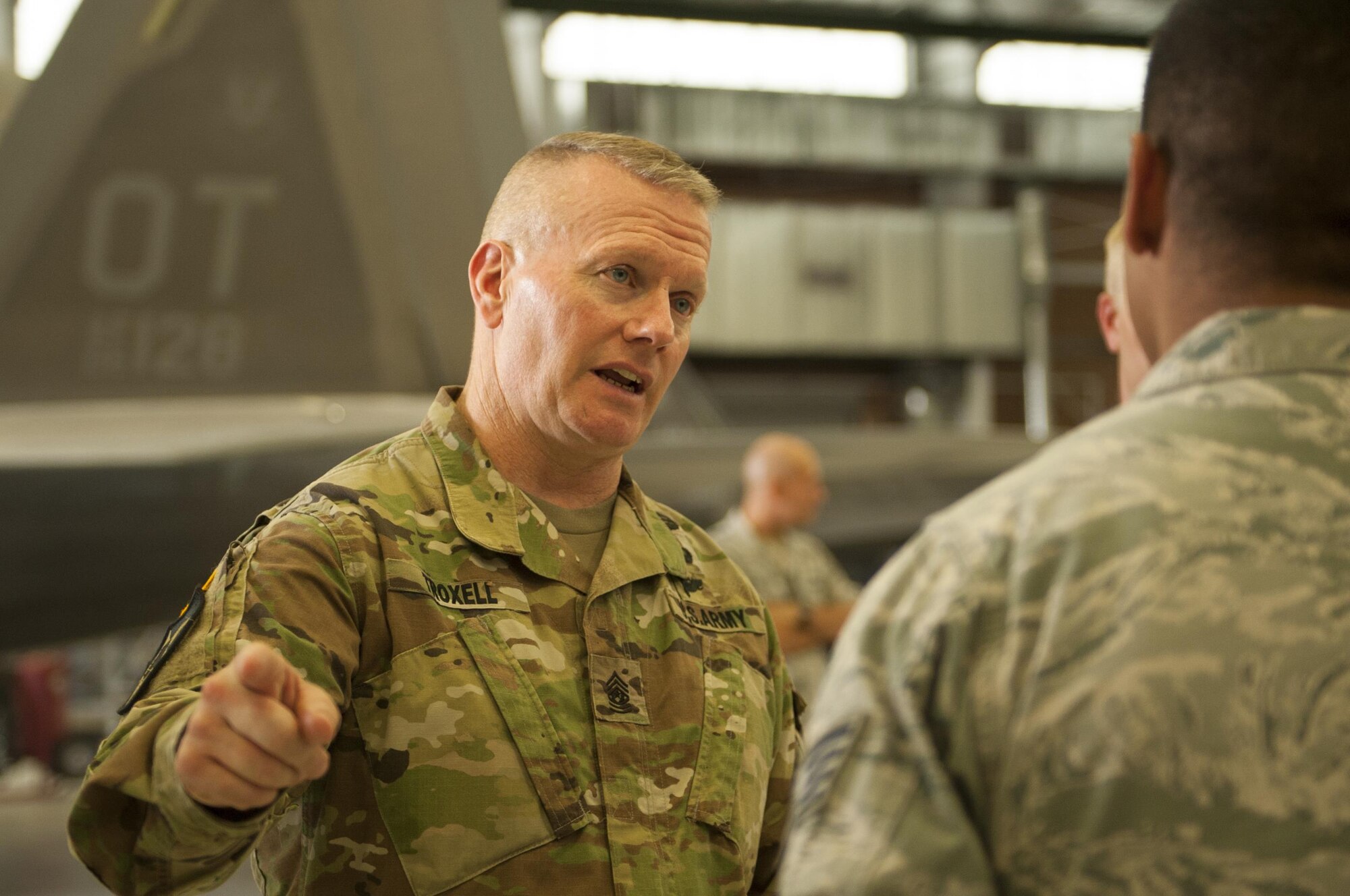Army Command Sgt. Maj. John Troxell, Senior Enlisted Advisor to the Chairman of the Joint Chiefs of Staff, speaks with Airmen from the 57th Maintenance Group during a Nellis Air Force Base, Nev., visit July 10, 2017. The SEAC is appointed to serve as an advisor to the Chairman and the Secretary of Defense on all matters involving joint and combined total force integration, utilization, health of the force, and joint development for enlisted personnel. (U.S. Air Force photo by Senior Airman Joshua Kleinholz)