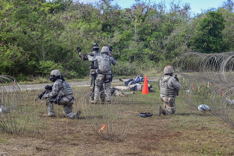 U.S. Air Force Airmen from the 644th Combat Communications Squadron captures an Airman acting as an opposing force during exercise Dragon Forge June 15, 2017, at Andersen South, Guam. Opposing forces repeatedly attacked the base throughout the day prior to an all-out final attack from all sides with the goal of overrunning the base. (U.S. Air Force photo by Airman 1st Class Christopher Quail)