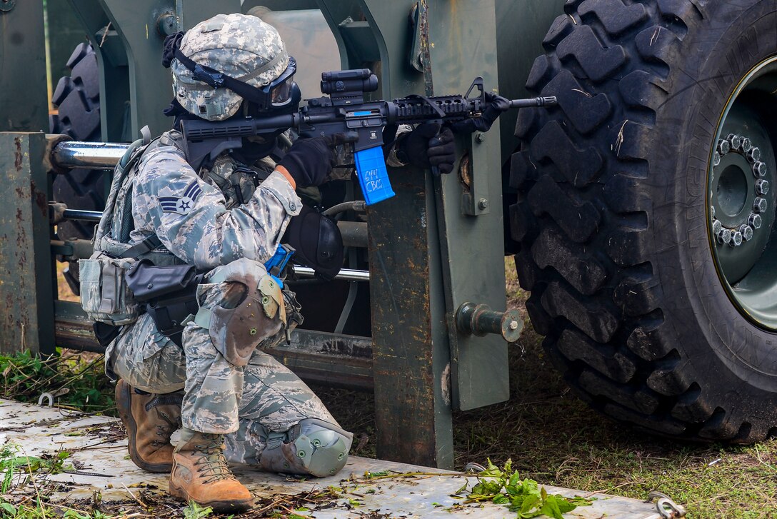 A U.S. Air Force Airman from the 644th Combat Communications Squadron takes cover behind a fork lift during exercise Dragon Forge June 15, 2017, at Andersen South, Guam. Opposing forces repeatedly attacked the base throughout the day prior to an all-out final attack from all sides with the goal of overrunning the base. (U.S. Air Force photo by Airman 1st Class Christopher Quail)