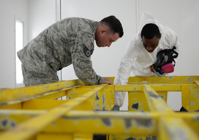 U.S. Air Force Staff Sgt. Brendan McCormick, 36th Maintenance Squadron corrosion control NCO in charge (left), and Senior Airman Jeremy Washington, 374th Maintenance Squadron aircraft structural maintenance journeyman, deployed from Yokota Air Base, Japan, inspect a weapons trailer June 27, 2017, at Andersen Air Force Base, Guam. Airmen began work in Andersen’s new temporary corrosion control facility June 5th. (U.S. Air Force photo by Senior Airman Alexa Ann Henderson)