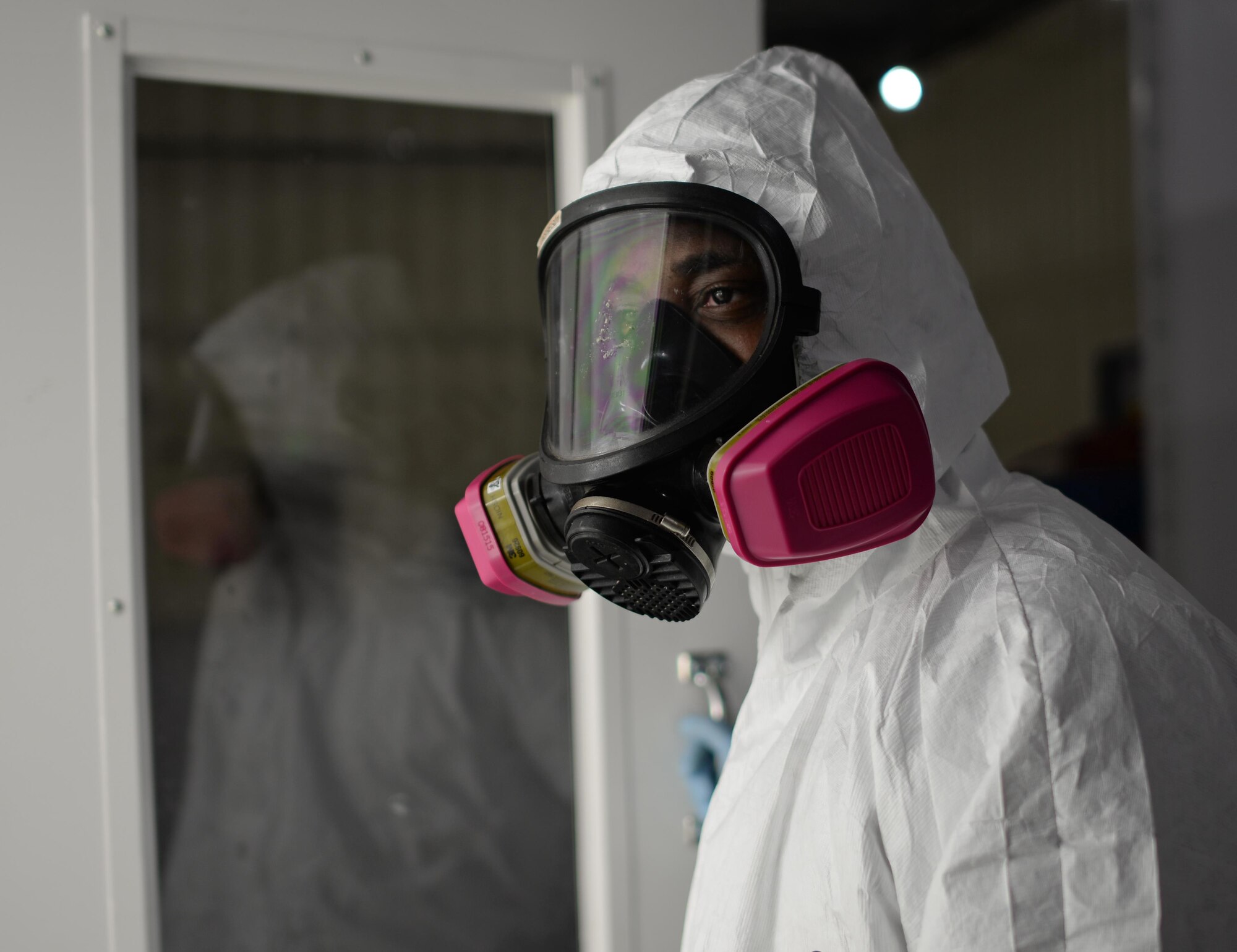 Senior Airman Jeremy Washington, 374th Maintenance Squadron aircraft structural journeyman, deployed from Yokota Air Base, Japan, walks into a sanding room in the new temporary corrosion control facility at Andersen Air Force Base June 27, 2017. Made of shipping containers, the facility meets all requirements set forth by the Department of Defense and Occupational Safety and Health Agency. (U.S. Air Force photo by Senior Airman Alexa Ann Henderson)