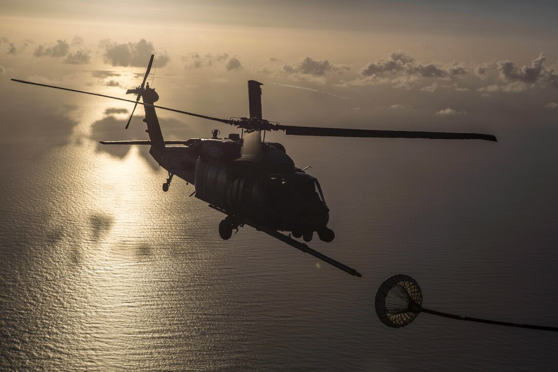 An Air Force HH-60G Pave Hawk helicopter receives fuel from an HC-130P/N King aircraft while traveling to assist in a rescue mission approximately 500 nautical miles off the east coast of southern Florida, July 7, 2017. About 80 airmen and four aircraft assigned to the 920th Rescue Wing assisted in the mission to rescue two German citizens whose vessel caught fire. Air Force photo by Master Sgt. Mark Borosch