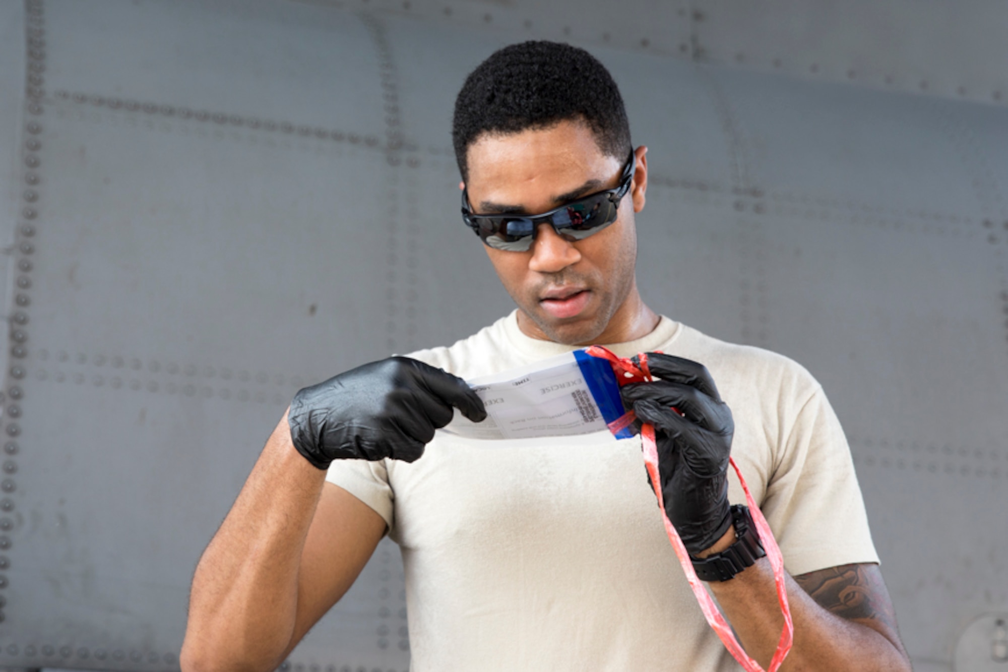 Senior Airman Frederick Broussard, 374th Medical Operations Squadron, reads an exercise inject card during a major accident response exercise at Yokota Air Base, Japan, July 10, 2017. The training exercise simulated a C-130 Hercules accident with varying levels of injuries. Personnel conducted the drill to ensure they are ready for any aircraft emergency. (U.S. Air Force photo by Yasuo Osakabe)