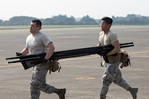 Senior Airman Jonathan Rodriguez and SrA Richson Bacay, both 374th Medical Operations Squadron aerospace medical technicians, carry a stretcher during a major accident response exercise at Yokota Air Base, Japan, July 10, 2017. The training exercise simulated a C-130 Hercules accident with varying levels of injuries. Personnel conducted the drill to ensure they are ready for any aircraft emergency. (U.S. Air Force photo by Yasuo Osakabe)