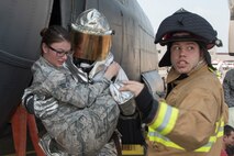 Firefighters from the 374th Civil Engineer Squadron carry a simulated aircraft accident victim during a major accident response exercise at Yokota Air Base, Japan, July 10, 2017. The exercise is conducted to test readiness and response times in case of a major accident. (U.S. Air Force photo by Yasuo Osakabe)