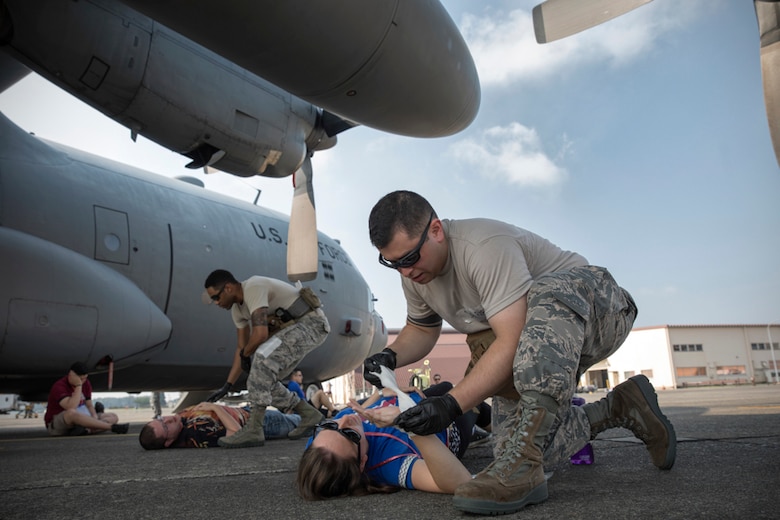 Senior Airman Jonathan Rodriguez and SrA Richson Bacay, both 374th Medical Operations Squadron aerospace medical technicians, carry a stretcher during a major accident response exercise at Yokota Air Base, Japan, July 10, 2017. The training exercise simulated a C-130 Hercules accident with varying levels of injuries. Personnel conducted the drill to ensure they are ready for any aircraft emergency. (U.S. Air Force photo by Yasuo Osakabe)