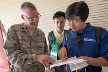 Lt. Col. Graham Warden, 374th Medical Operations Squadron commander, explains an exercise inject card to emergency response personnel from the Kyorin University Hospital during a major accident response exercise at Yokota Air Base, Japan, July 12, 2017. This is the first time Japanese emergency response personnel from the Kyorin University Hospital and Japan Air Self-Defense Force from the Air Defense Command participated in a MARE ensuring they are ready for any aircraft emergency. (U.S. Air Force photo by Yasuo Osakabe)