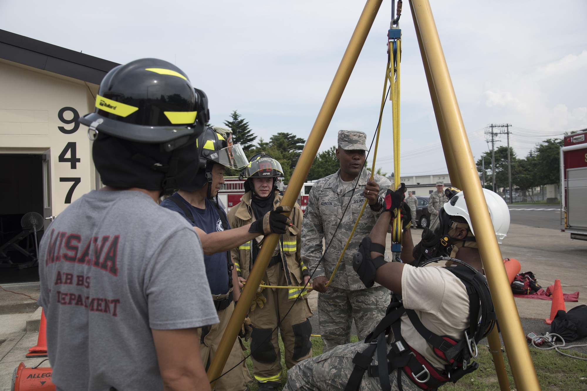 U.S. Air Force Chief Master Sgt. Anthony Johnson, the Pacific Air Forces' command chief, watches 35th Civil Engineer Squadron firefighters demonstrate entering a confined space using a tripod, at Misawa Air Base, Japan, July 11, 2017. Johnson, once a security forces troop, now oversees more than 40,000 enlisted personnel in his position and advises the PACAF commander on all matters affecting the readiness, training, professional development and effective utilization of assigned enlisted members. (U.S. Air Force photo by Airman 1st Class Sadie Colbert)