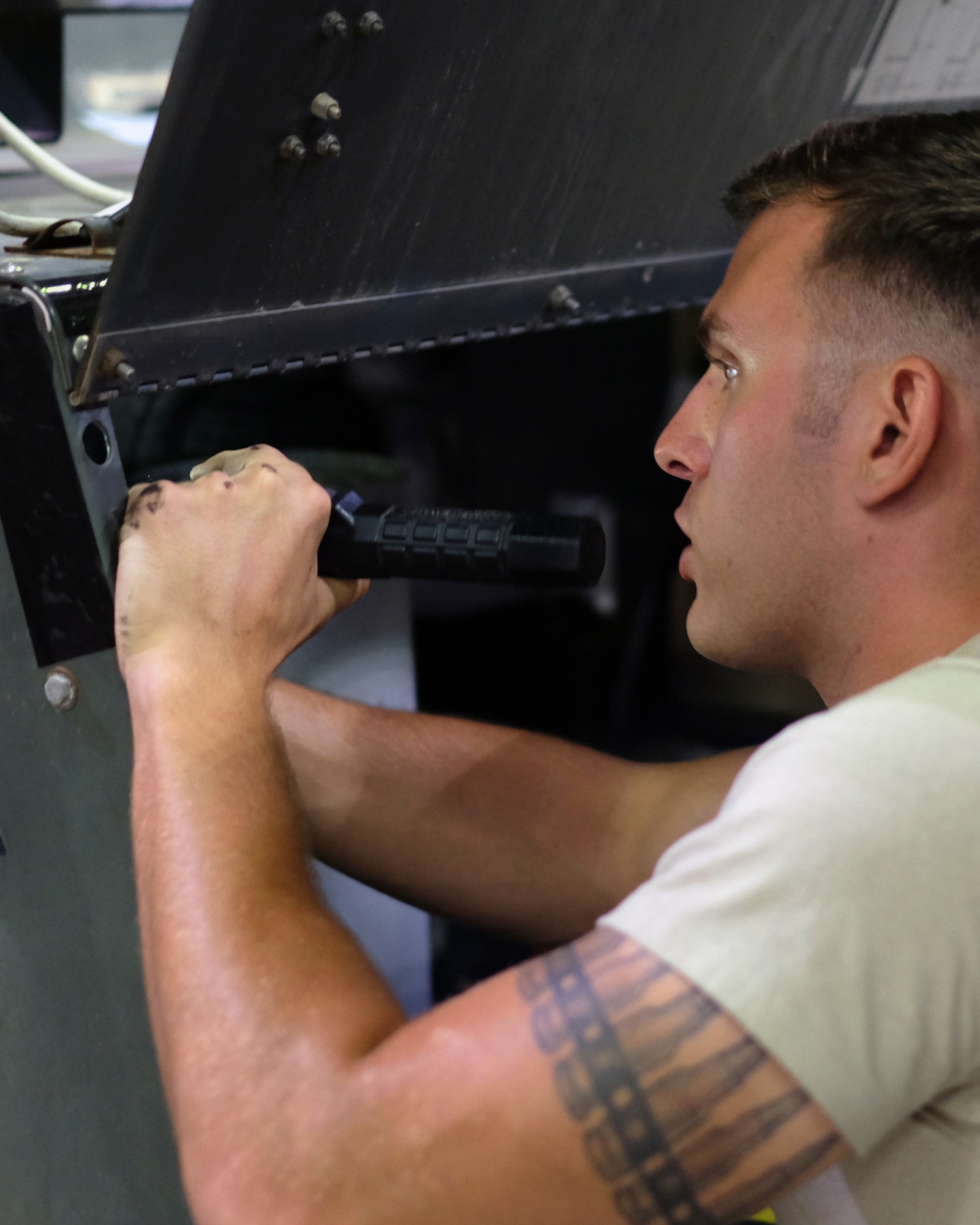 Senior Airman Nathan, 380th Expeditionary Maintenance Squadron aerospace ground equipment journeyman, inspects a floodlight July 12, 2017, at an undisclosed location in southwest Asia. AGE flight members work 24/7 overcoming obstacles in the AOR to ensure equipment needed to launch aircraft are always ready when needed. (U.S. Air Force photo by Senior Airman Preston Webb)