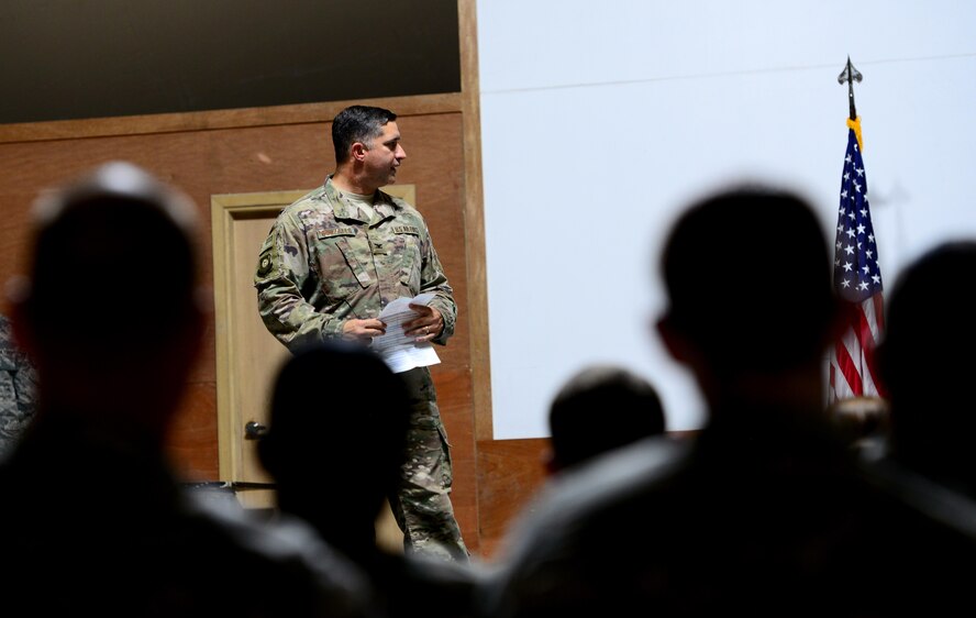 U.S. Air Force Col. John Gonzales, 407th Air Expeditionary Group commander, addresses the 407th AEG, coalition partners, and U.S. Marines during the 407th Expeditionary Communications Squadron change of command ceremony on July 11, 2017 in Southwest Asia. This ceremony signified the transfer of command between the outgoing commander Lt. Col. Dean Benson and the incoming commander Maj. Charlie Grover to the 407th AEG. (U.S. Air Force Tech. Sgt. Andy M. Kin)