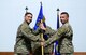 U.S. Air Force Col. John Gonzales, 407th Air Expeditionary Group commander, takes the guidon from Lt. Col. Dean Benson relinquishing him of command during the 407th Expeditionary Communications Squadron change of command ceremony July 11, 2017, in Southwest Asia. Maj. Charles Grover assumes command of the 407th ECS. (U.S. Air Force photo by Tech. Sgt. Andy M. Kin)