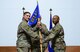 U.S. Air Force Col. John Gonzales, 407th Air Expeditionary Group commander, passes the guidon to Maj. Charlie Grover, as Grover assumes command of the 407th Expeditionary Communications Squadron July 11, 2017, in Southwest Asia. The passing of the guidon represents a formal transfer of authority and responsibility from an outgoing commander to an incoming one. (U.S. Air Force photo by Tech. Sgt. Andy M. Kin)