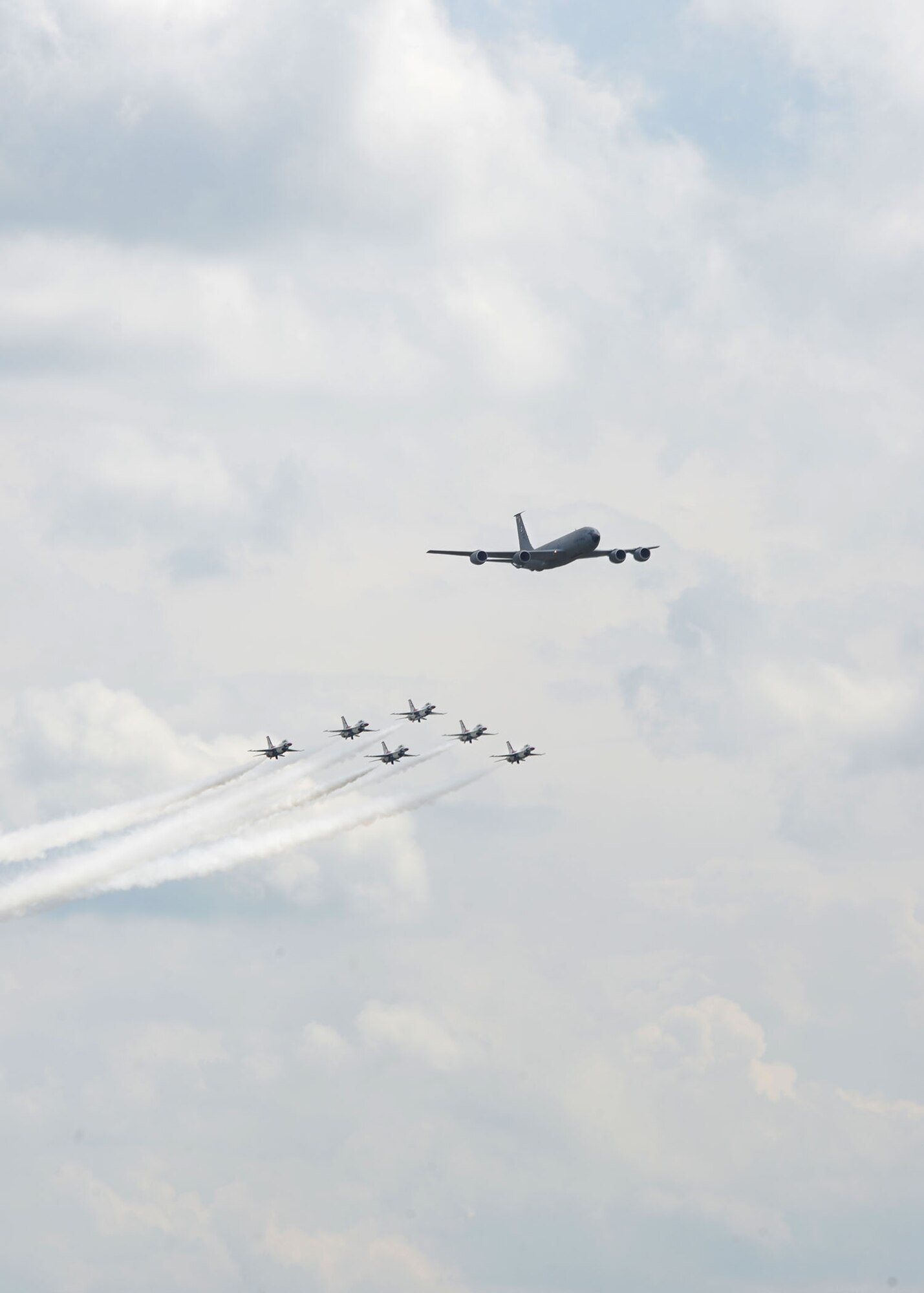 A KC-135 Stratotanker from the 100th Air Refueling Wing leads the U.S. Air Force Thunderbirds as they fly in formation July 10, 2017, over RAF Mildenhall and RAF Lakenheath, England. The elite flying display team were in the area on their way to the Royal International Air Tattoo at RAF Fairford, and practice for Bastille Day events in France. (U.S. Air Force photo by Karen Abeyasekere)