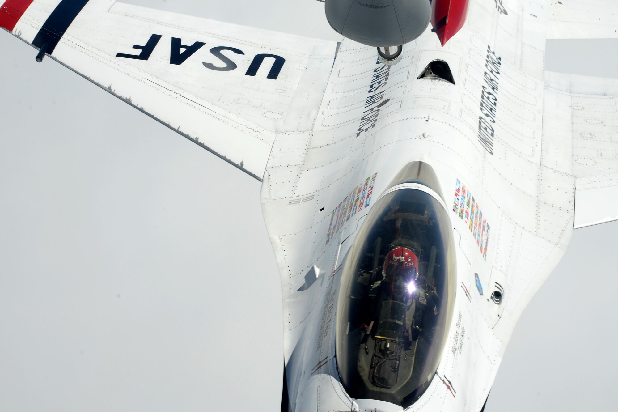 A U.S. Air Force Thunderbird pilot maneuvers towards the boom of a KC-135 Stratotanker, assigned to the 351st Air Refueling Squadron, July 10, 2017, during a refueling mission over the United Kingdom. The Thunderbirds are in the European theater for Bastille Day and the 2017 Royal International Air Tattoo airshow. (U.S. Air Force photo by Senior Airman Justine Rho)