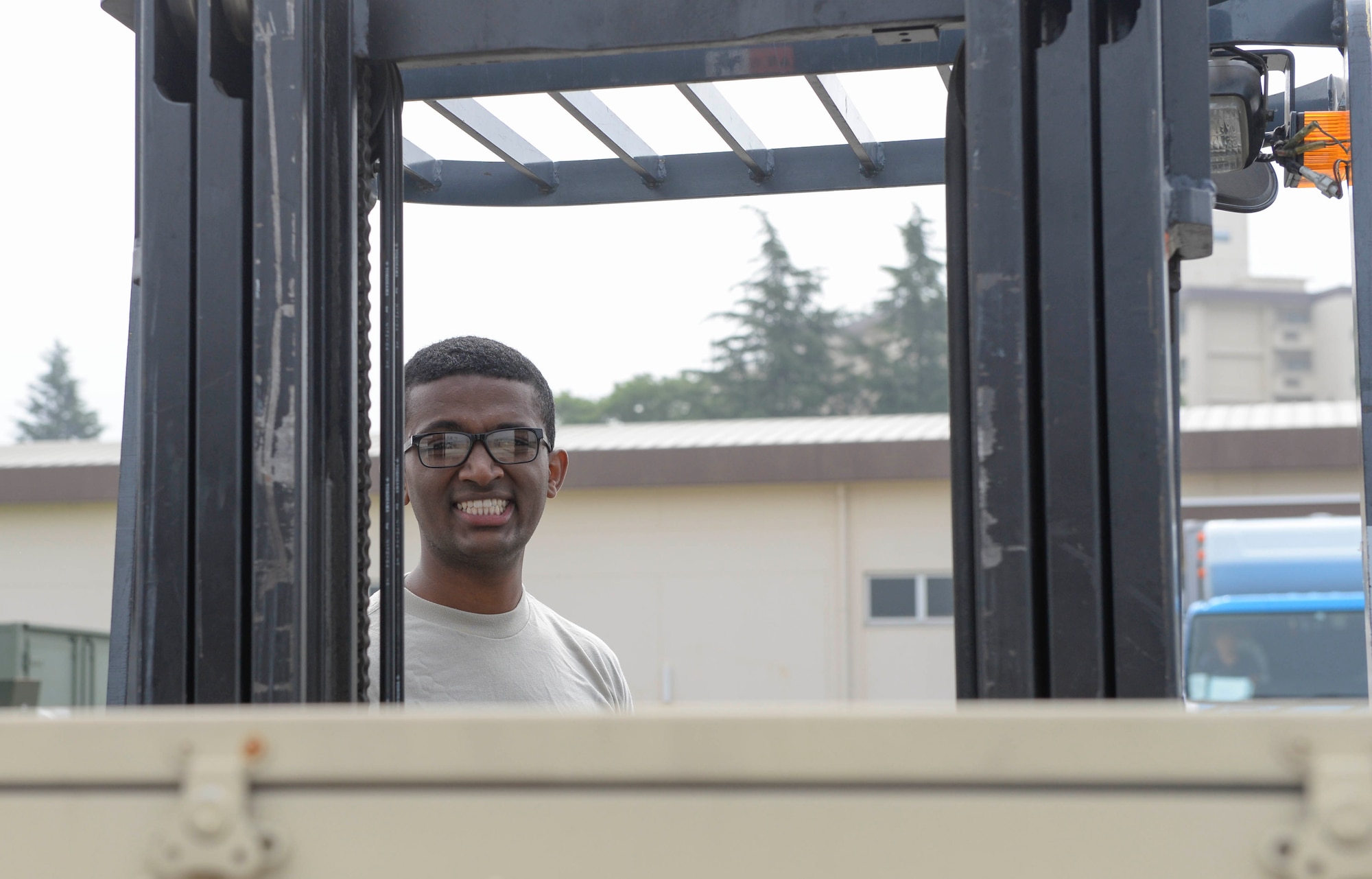 Airman 1st Class Biruk Heim, 374th Medical Support Squadron technician, smiles while on a forklift, June 29, 2017, at Yokota Air Base, Japan. The medical supplies included; En-Route Patient Staging Systems, electrical cooling units along with other medical supplies that would be used for any emergencies or contingency operations.